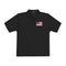 Black polo shirt with a small flag patch on a white background