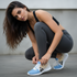 Argentine woman crouching to show Javier Milei Afuera sneakers close-up