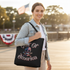 Woman wearing Gulf of America Skull Tote Bag on shoulder
